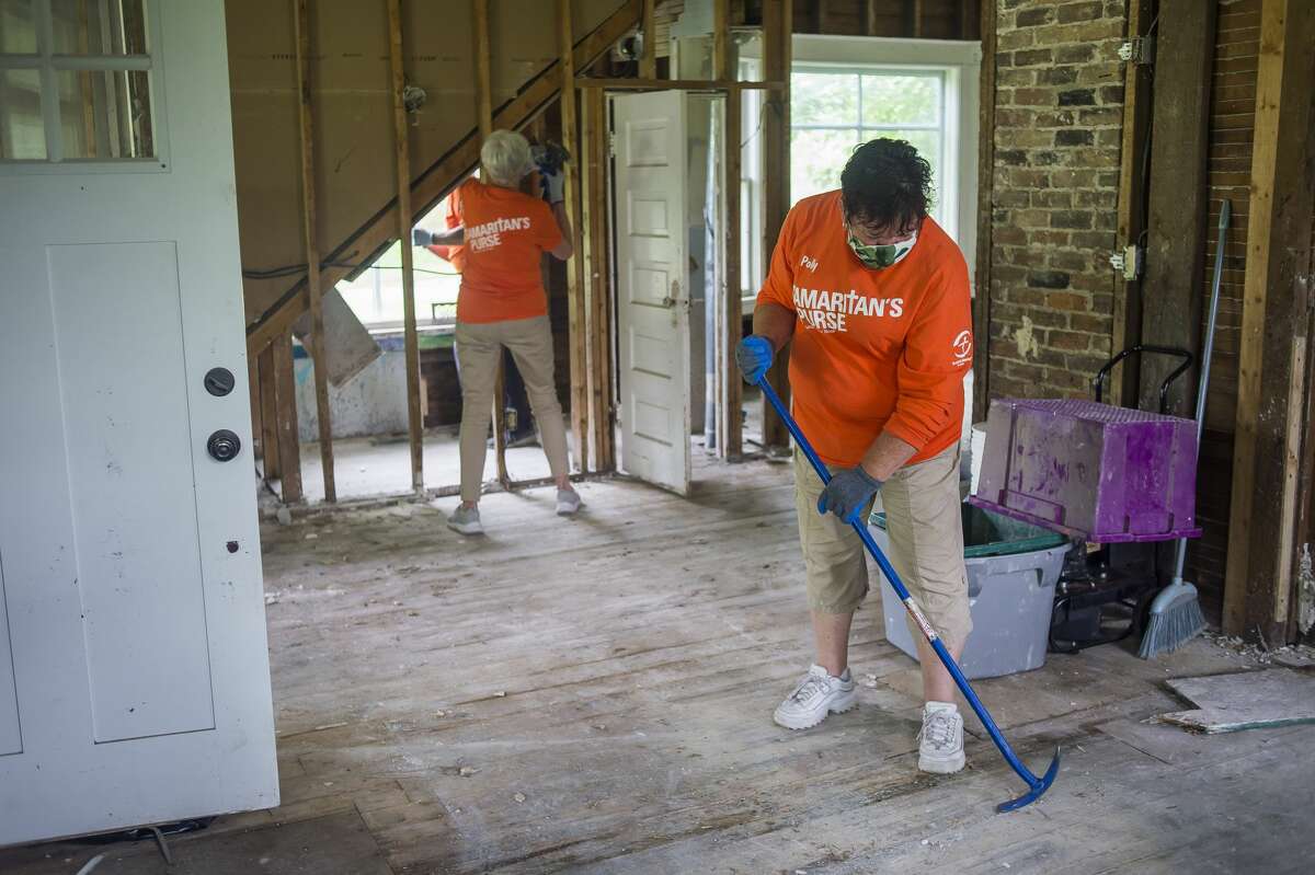 Volunteers with Samaritan's Purse finish up their work on a home on E. Pine River Road Friday, June 26, 2020 in Midland. Over the course of five weeks, the organization has employed the assistance of 1,500 volunteers to aid over 300 area families with flood relief. (Katy Kildee/kkildee@mdn.net)