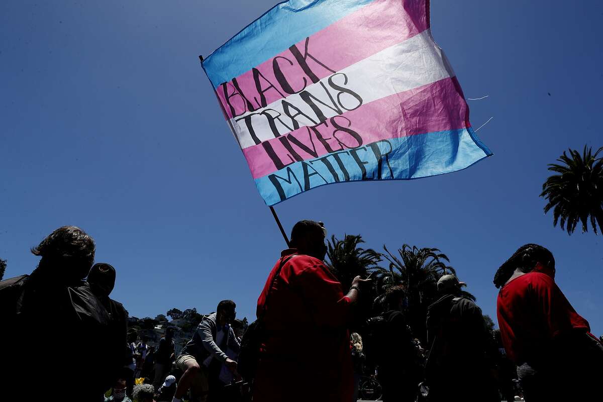Raymond Quitugua of Sacramento, carries the Trans Flag during a march for equality for Black, indigenous and people of color and calling for defunding the police in San Francisco, Calif., on Sunday, June 28, 2020. Those in attendance gathered to honor LGBTQ freedom fighters who paved the way to call for the liberation of Black, Brown and Indigenous people, and to demonstrate that trans and queer people are in this fight.