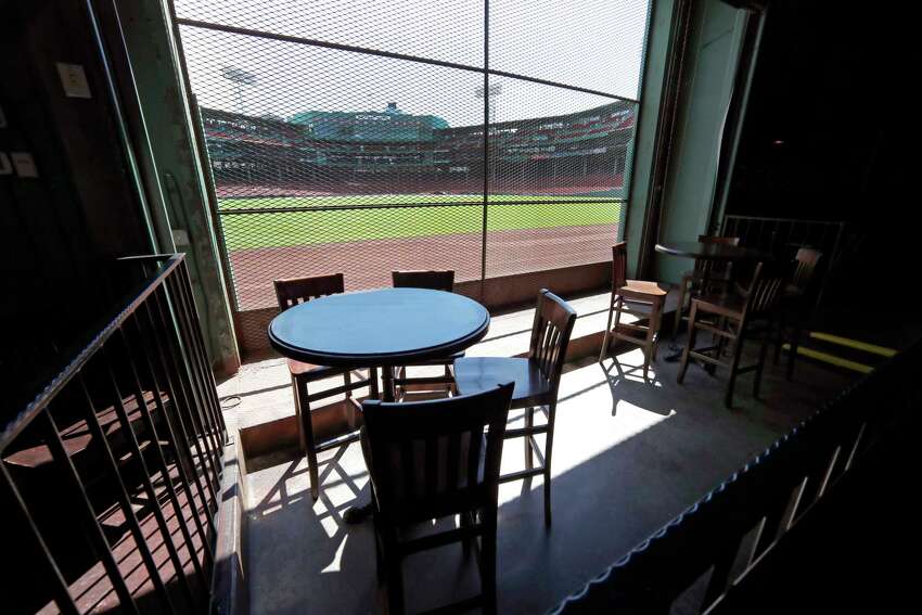This June 25, 2020, photo shows the view of the baseball field at Fenway Park from the Bleacher Bar in Boston. Located inside the outfield structure at Fenway, it might be one of the few places where fans can watch live MLB baseball this year. Like the Knothole Gangs of the sport's early days, fans hoping to catch a glimpse of a ballgame in person this season will be pressing their faces up against hotel windows, peering through metal grates or clambering up to rooftops when baseball returns this month in otherwise empty stadiums. (AP Photo/Elise Amendola)