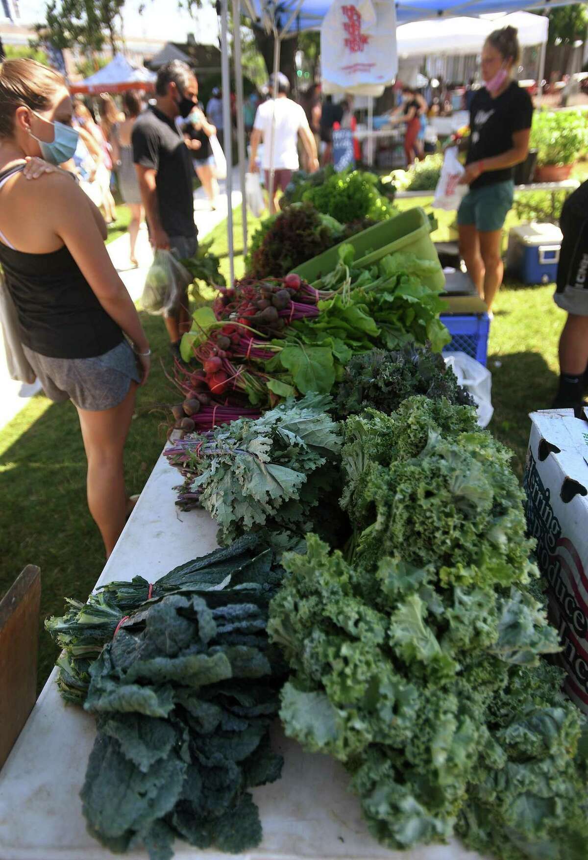 Fresh produce is spread out for purchase in Nature View Farm's booth during the opening day of the Fairfield Farmers Market on Sherman Green in Fairfield, Conn. on Sunday, June 28, 2020.