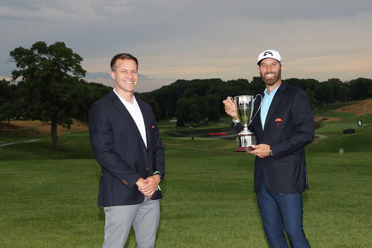 Dustin Johnson of the United States poses with the trophy after winning the Travelers Championship at TPC River Highlands on Sunday in Cromwell.