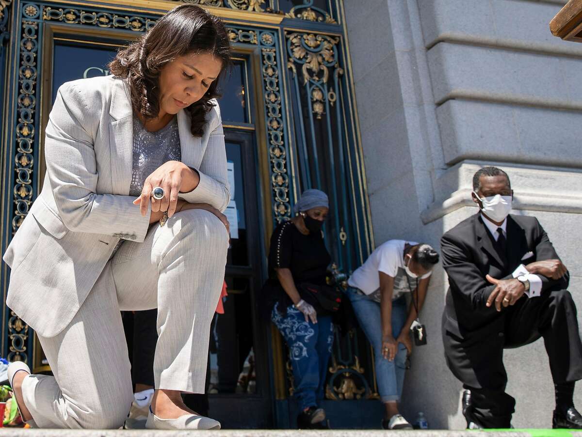 In honor of George Floyd, San Francisco Mayor London Breed takes a knee for eight minutes and 46 seconds with thousands of people during a rally at City Hall, Tuesday, June 9, 2020, in San Francisco, Calif. Black Lives Matter demonstrations in the Bay Area and protests in the nation continued following the death of George Floyd, who died restrained by Minneapolis police officers on Memorial Day. Minneapolis police officer Derek Chauvin is charged with third-degree murder and second-degree manslaughter for the death of Floyd. Chauvin had kept his knee on Floyd’s neck for eight minutes and 46 seconds.