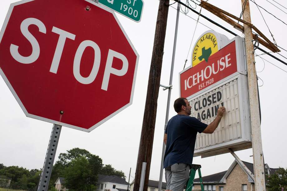 Bar owner Petros J Markantonis changes the marquee outside his bar to "Closed Again" at the West Alabama Ice House in Houston, Texas on June 26, 2020. Photo: MARK FELIX/AFP /AFP Via Getty Images