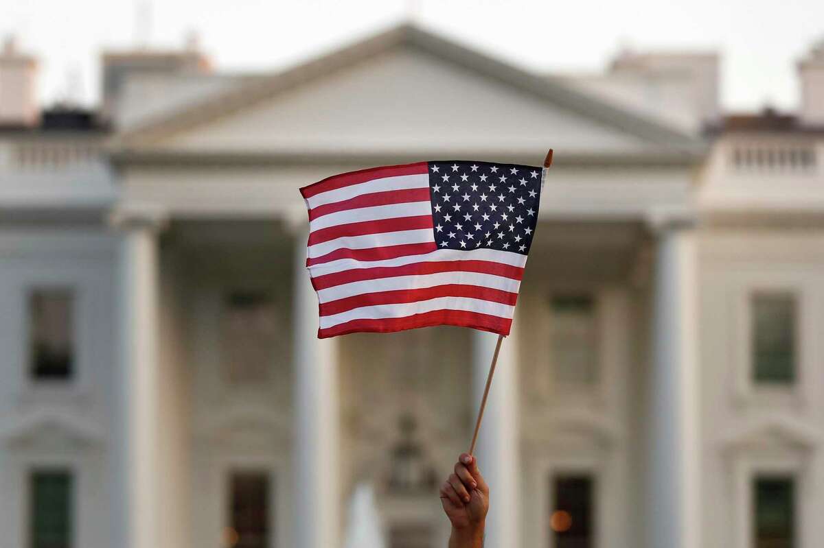 A flag is waved outside the White House, in Washington.