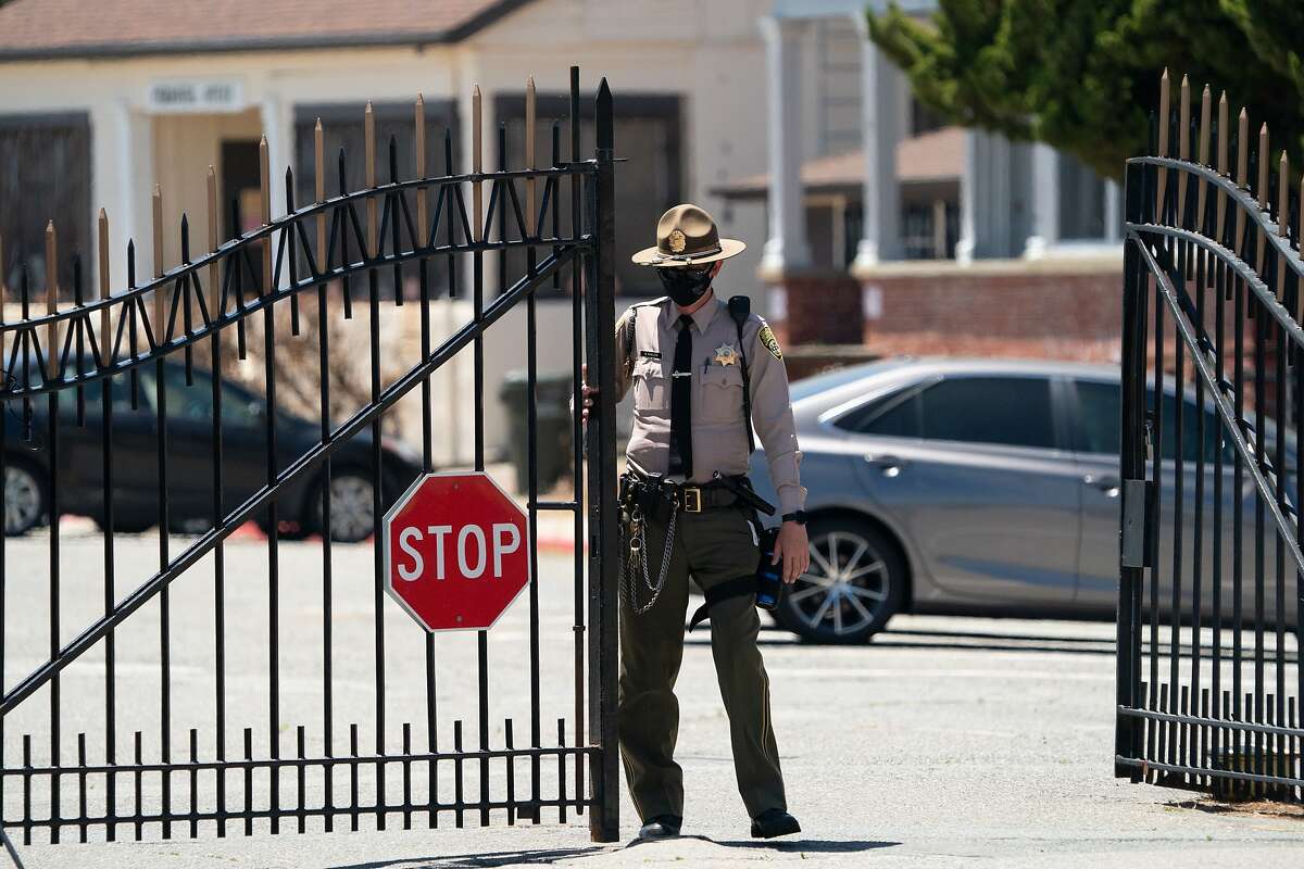 A guard closes the gates at San Quentin during the Stop San Quentin Outbreak rally on Sunday, June 28, 2020 in San Rafael, Calif.