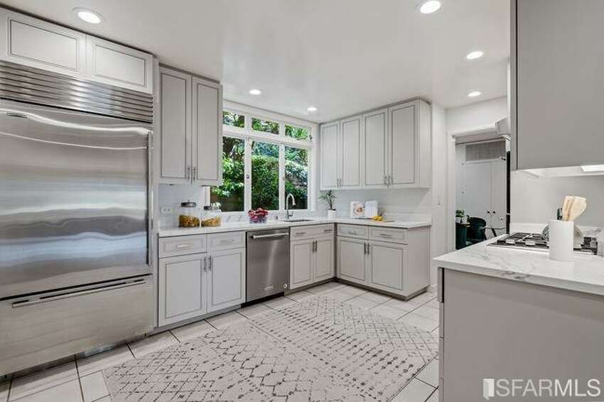 During their long-term ownership of the home, the Schusters updated the kitchen with Carrera marble counters and stainless steel appliances.