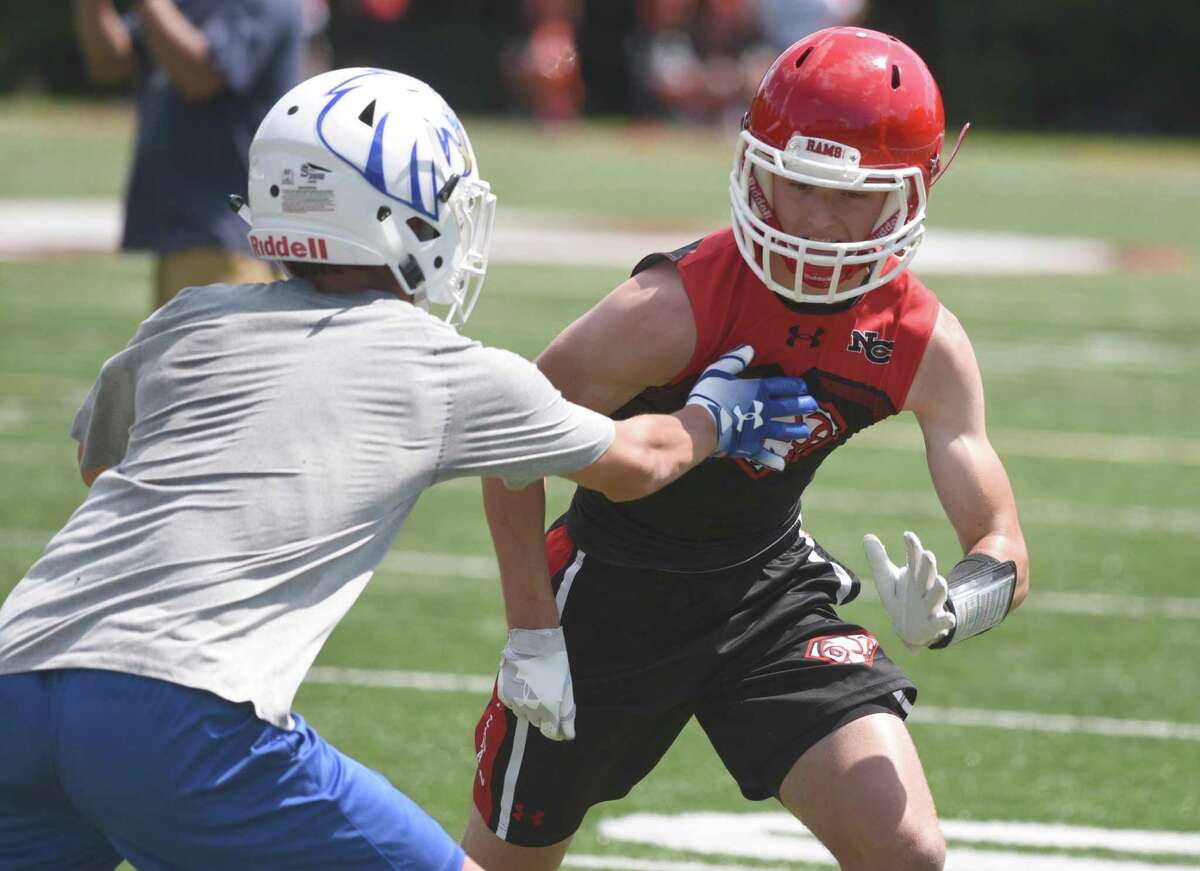 New Canaan’s Maddox Underwood goes against a Newington defender during the annual Grip It and Rip It football tournament in New Canaan on Friday, July 12, 2019.