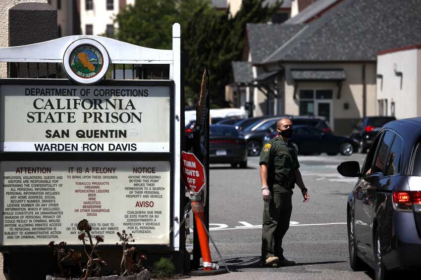 A California Department of Corrections and Rehabilitation (CDCR) officer wears a protective mask as he stands guard at the front gate of San Quentin State Prison on June 29, 2020 in San Quentin, California. San Quentin State Prison is continuing to experience an outbreak of coronavirus COVID-19 cases with over 1,000 confirmed cases amongst the staff and inmate population. San Quentin had zero cases of COVID-19 prior to a May 30th transfer of 121 inmates from a Southern California facility that had hundreds of active cases 13 COVID-19-related deaths.