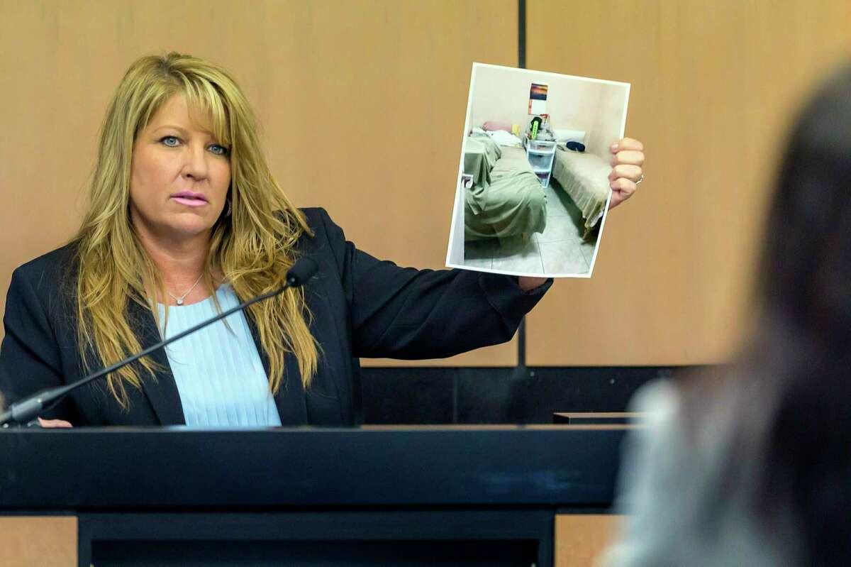 FILE- In this April 30, 2019, file pool photo, Karen Herzog, a Florida Department of Health inspector, shows a photo she took of beds in a room during her inspection of Orchids of Asia Day Spa, during a motion hearing in the Robert Kraft prostitution solicitation case in West Palm Beach, Fla. Florida prosecutors will try to save their prostitution solicitation case against New England Patriots owner Kraft when they argue before an appellate court Tuesday, June 30, 2020, that his rights weren't violated when police secretly video recorded him allegedly paying for sex at a massage parlor. (Lannis Waters/The Palm Beach Post via AP, Pool, File)