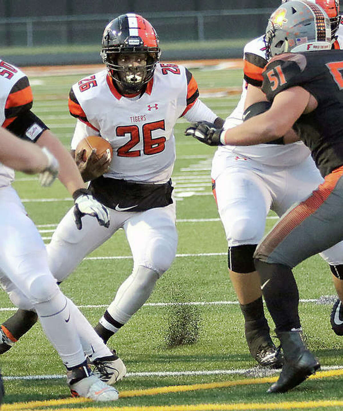 Edwardsville running back Justin Johnson (26) looks for running room out of the Wildcat formation during a Class 8A second-round playoff game Nov. 8 in Minooka.
