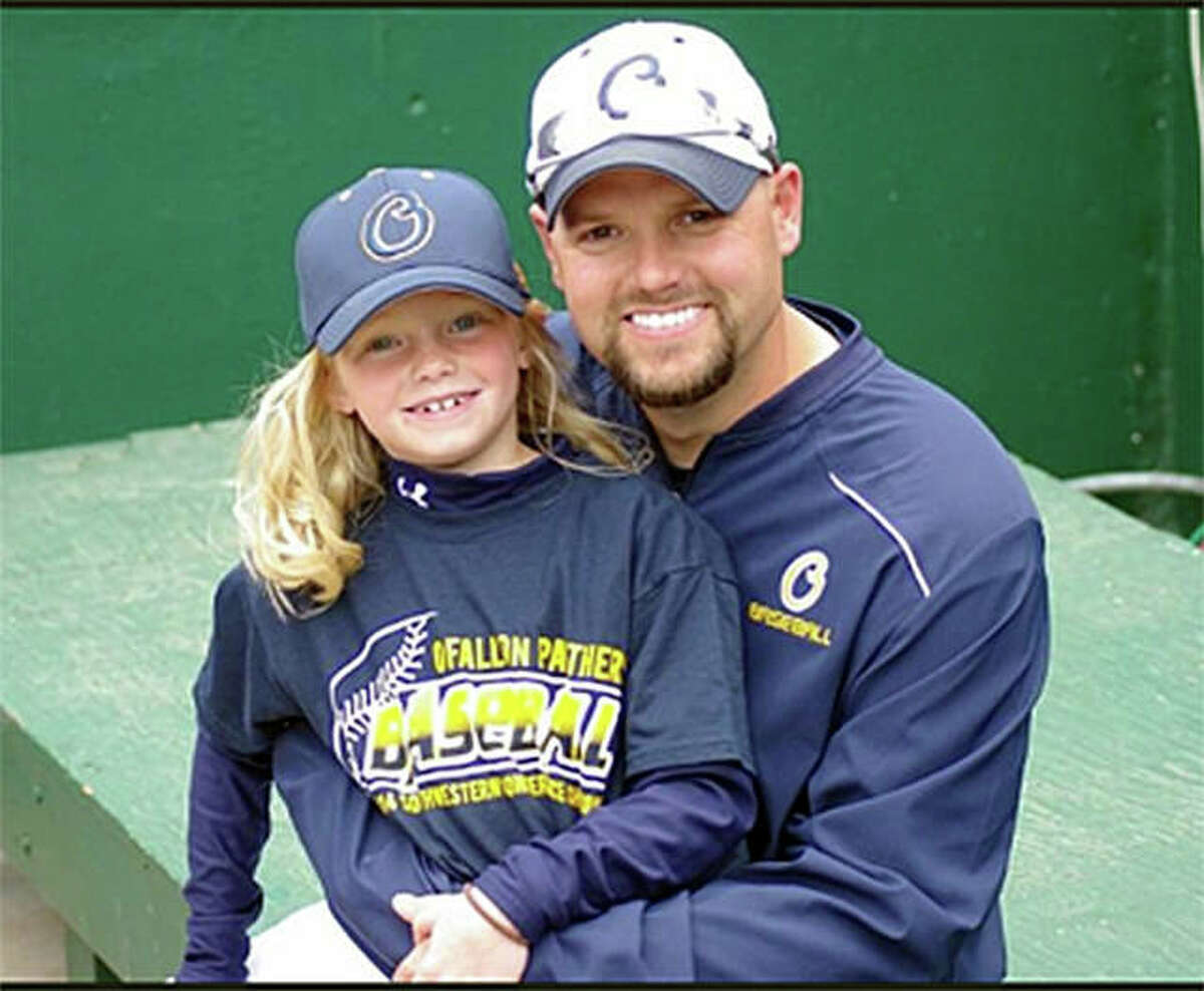 Edwardsville graduate Nick Seibert poses for a photo with his daughter Addison when he was the pitching coach at O’Fallon High School.