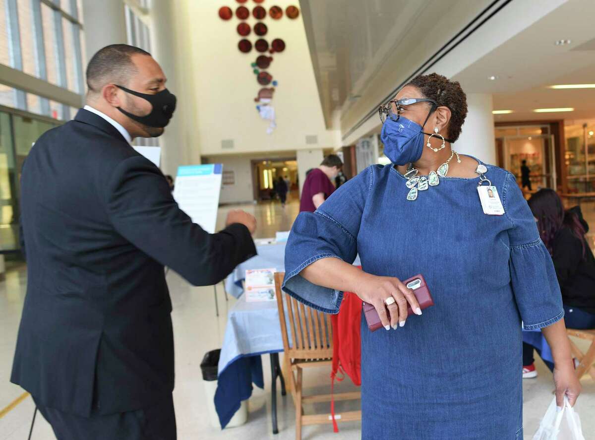 Bexar County Commissioner Tommy Calvert elbow bumps with Tommye Austin, chief nurse executive at University Hospital, recently. Calvert said Tuesday that San Antonio needs to do all it can to improve testing and contract tracing for COVID-19, using other countries and U.S. cities as models.