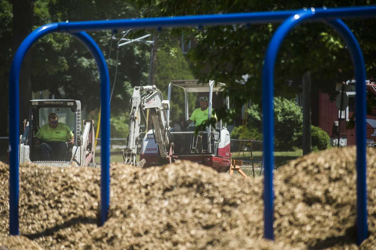 Construction work continues at Grove Park Tuesday, June 30, 2020 in Midland. The project includes added walkways, a new play area, a new basketball court, added trees and greenery and a new 60-space parking lot. (Katy Kildee/kkildee@mdn.net)