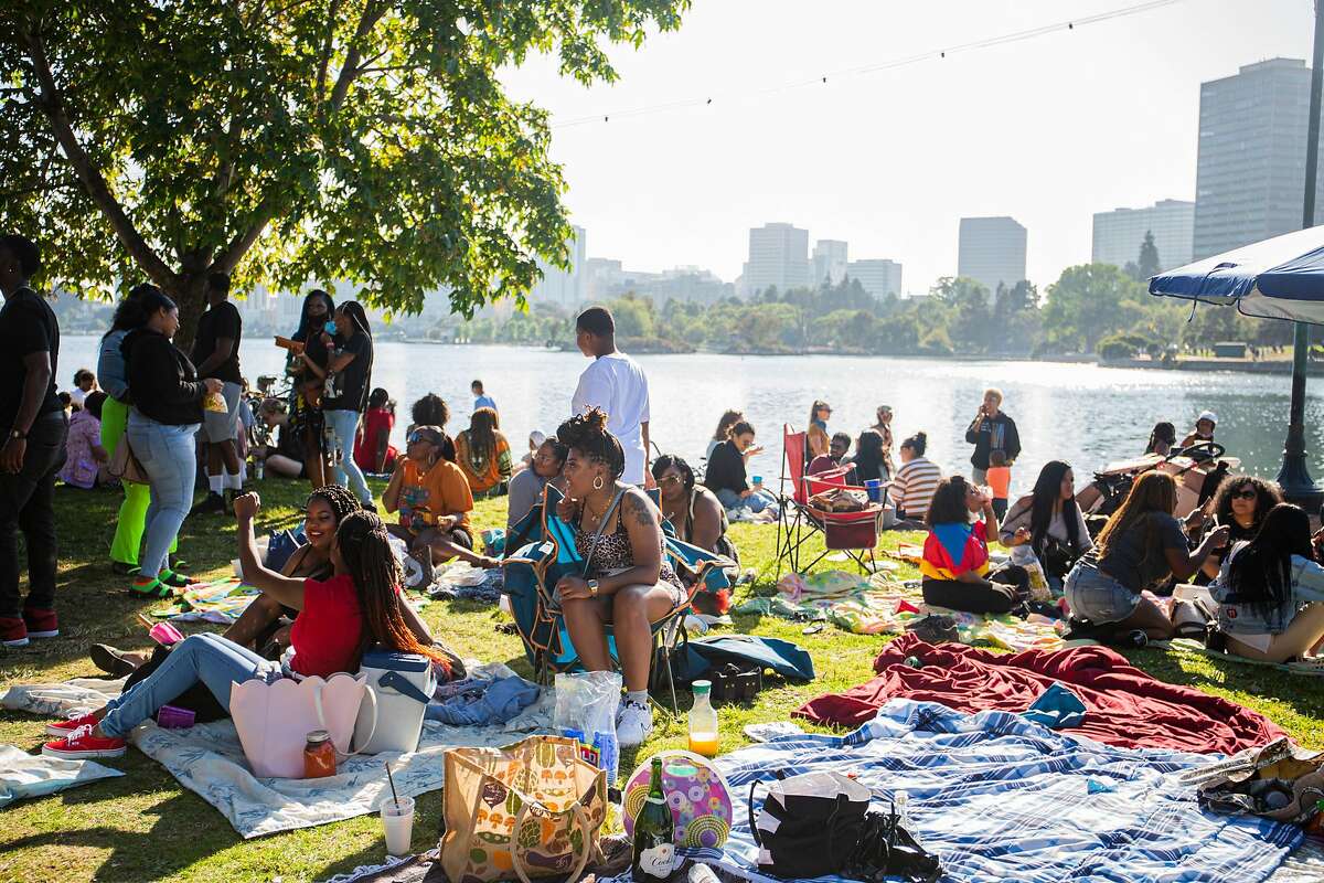 Groups of people gather by Lake Merrit in Oakland on June 19, 2020.
