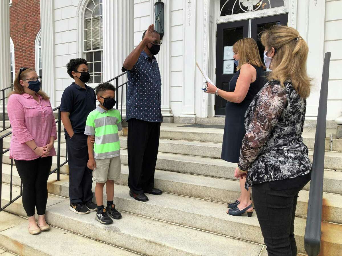Stratford Town Clerk Susan Pawluk swears in Lorenzo Elder as a member of the Stratford Board of Zoning Appeals June 30, 2020 as Elder’s wife, Jessica, sons Carter and Chance, and Mayor Laura Hoydick look on.