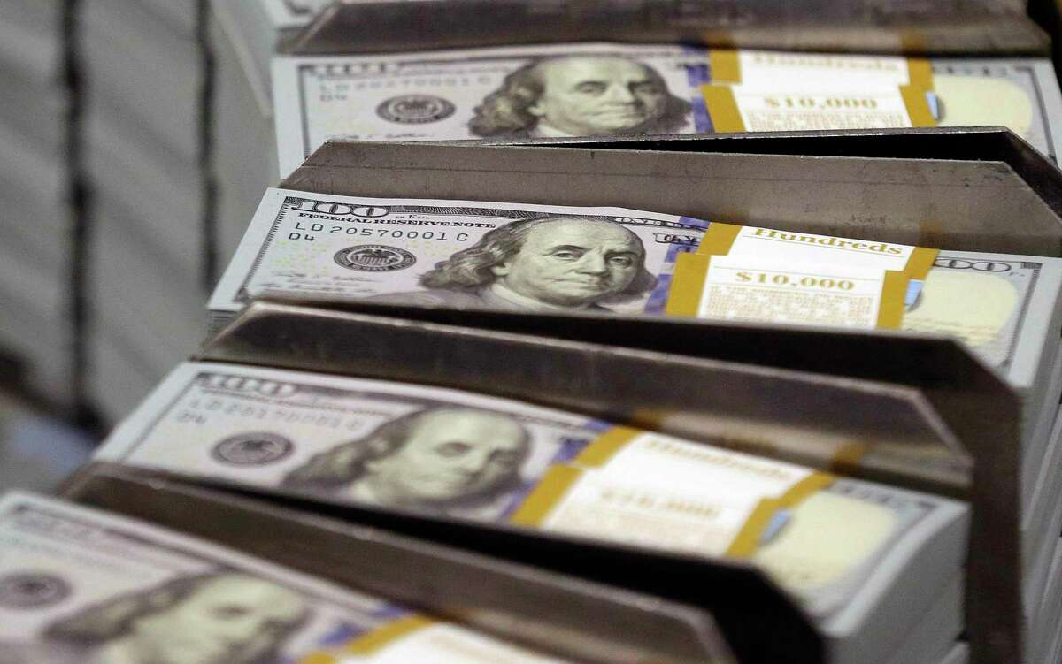 FILE - In this Sept. 24, 2013, file photo, freshly cut stacks of $100 bills make their way down the line at the Bureau of Engraving and Printing Western Currency Facility in Fort Worth, Texas. Workers are setting aside more of their paychecks in their 401(k), and lower-income workers are much more likely to be saving than years ago, according to the latest data from Vanguard, released in June 2017. (AP Photo/LM Otero, File)