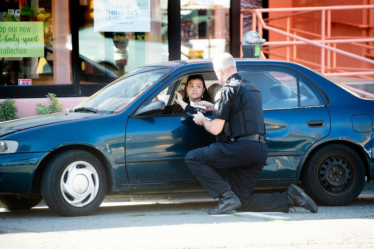 A driver, who declined to be identified, receives a warning from Berkeley police Sgt. Rittenhouse during a crackdown on railroad crossing violations in Berkeley, Calif., on Tuesday, Sept. 24, 2019. Sgt. Rittenhouse said the motorist drove around a closed railroad crossing gate as a train approached.