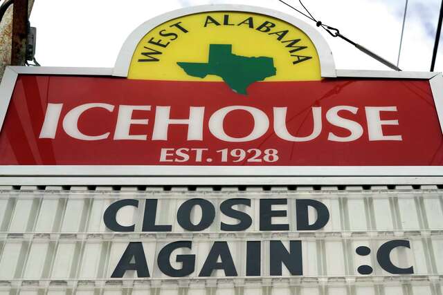 A sign outside the West Alabama Icehouse shows the bar is closed Monday, June 29, 2020, in Houston. Texas Gov. Greg Abbott shut down bars again and scaled back restaurant dining on Friday as cases climbed to record levels after the state embarked on one of America's fastest reopenings. (AP Photo/David J. Phillip)