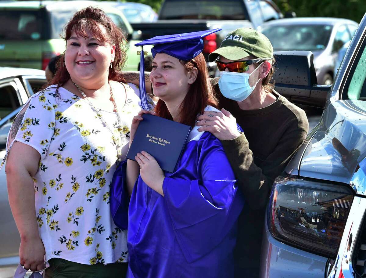 West Haven, Connecticut - Tuesday, June 30, 2020: West Haven High School holds a speedy drive-in graduation ceremony Tuesday evening as seniors arrive in waves of 35 cars at a time,walk up to the stage and receive their diplomas, and have their photographs made in cap & gowns. Approximately 381 seniors graduated from the high school.