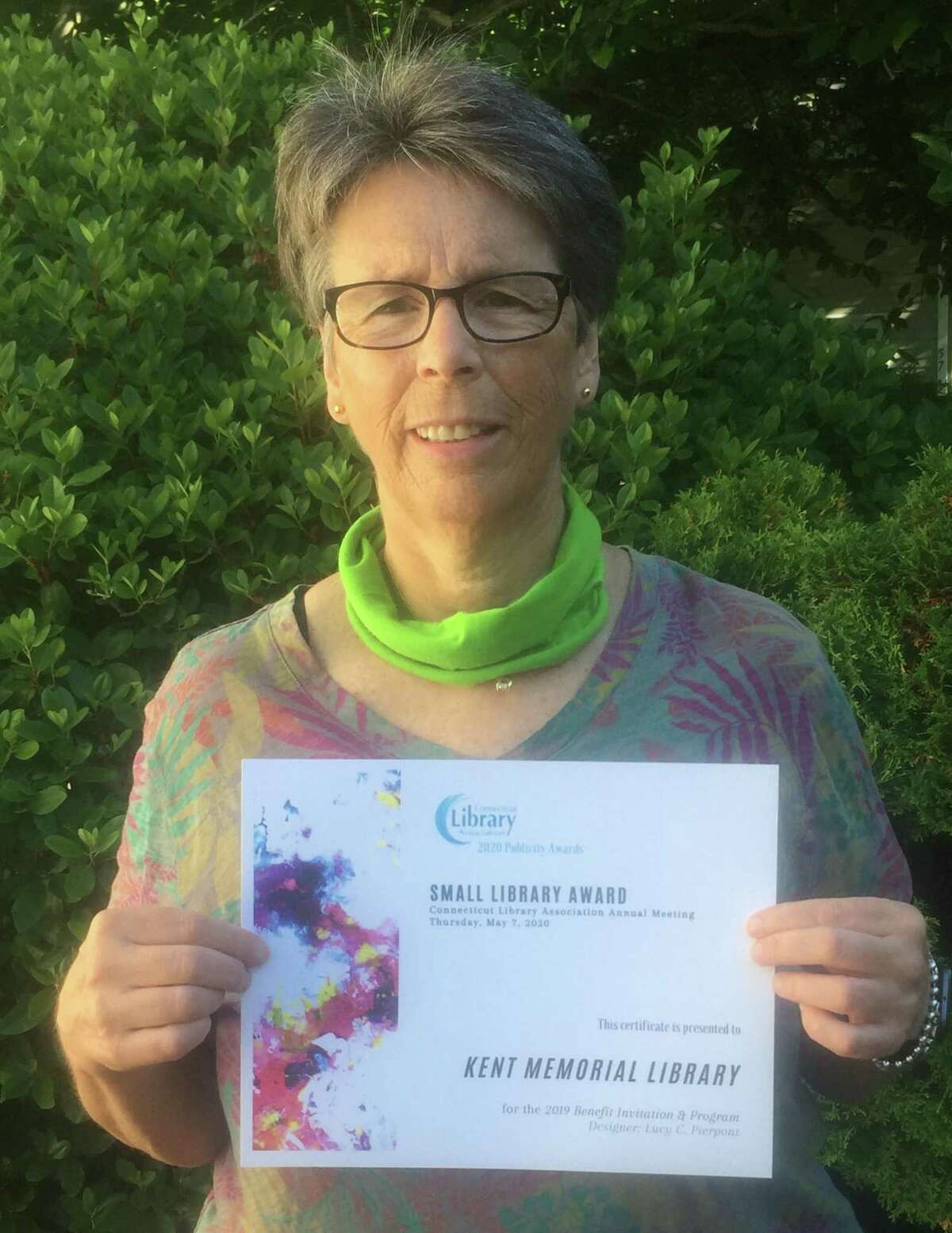 Lucy Pierpont, a Woodbury resident and Kent Memorial Library's marketing and special events director, holds the award won for Outstanding Design in the Small Library Category for the invitation and program materials for the 2019 Annual Benefit fundraising event in Kent.