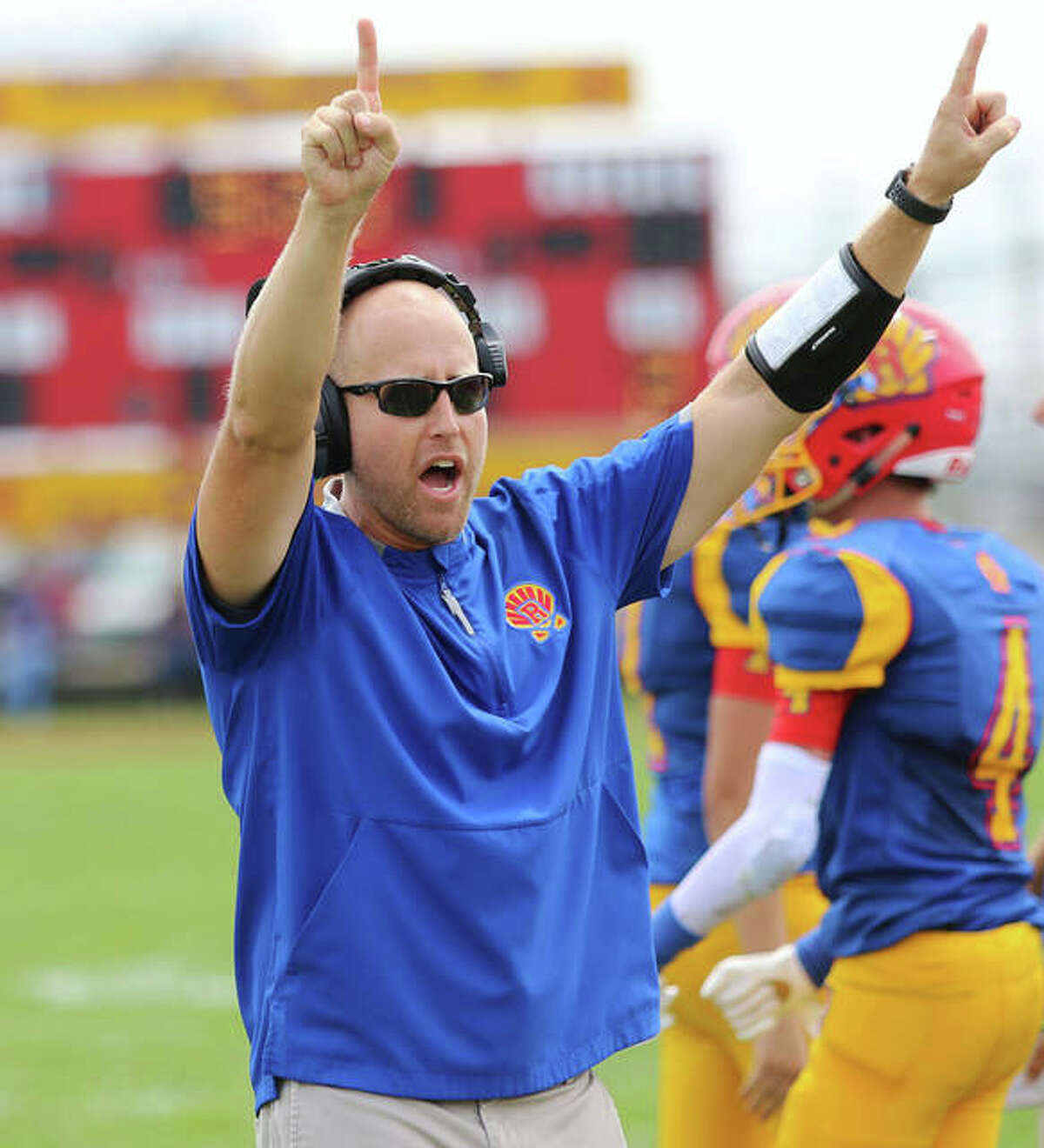 Roxana coach Wade DeVries signals for the PAT unit after a Shells touchdown in last season’s opener at Raich Field in Roxana. DeVries, in his second year at Roxana, is the 2019 Telegraph Small-Schools Football Coach of the Year.