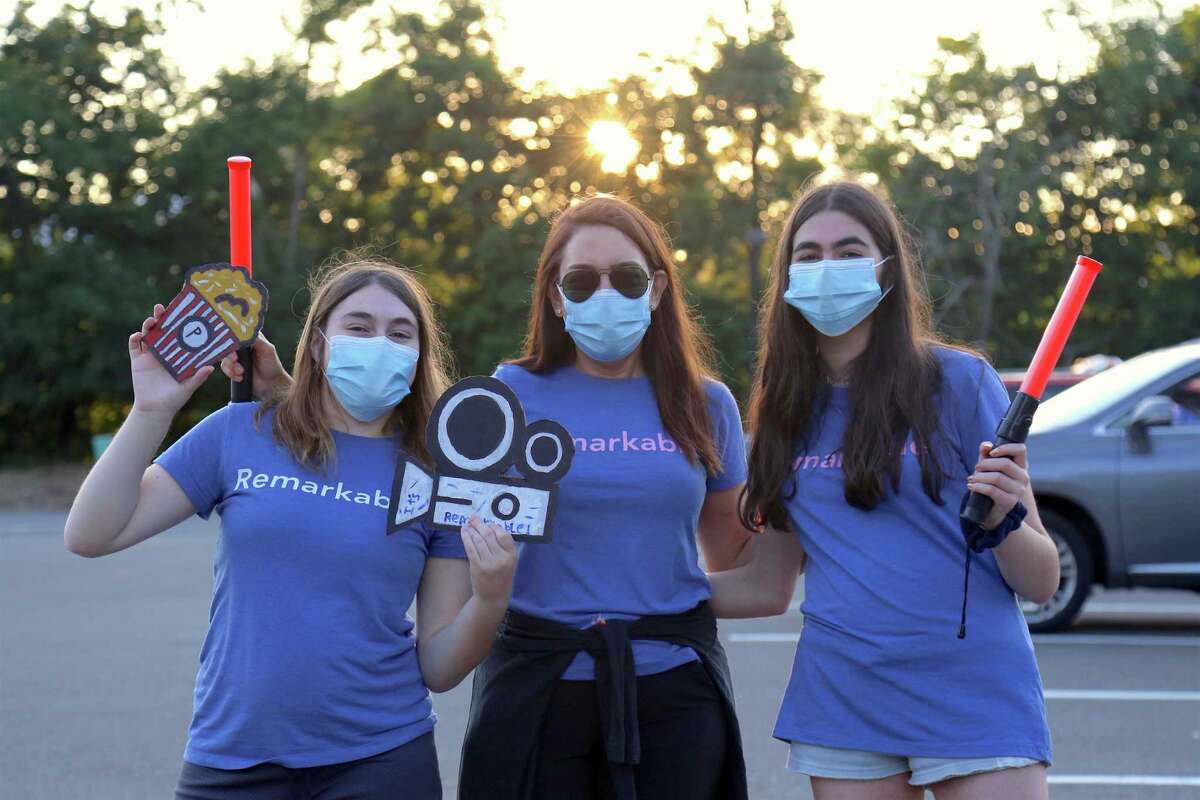 A family of volunteers, including, from left, Maya Treisman, mom Margi Jacobson, and Jojo Treisman, 14, of Westport at the drive-in premiere of the new Remarkable Theater on Friday, June 27, 2020, in Westport, Conn.