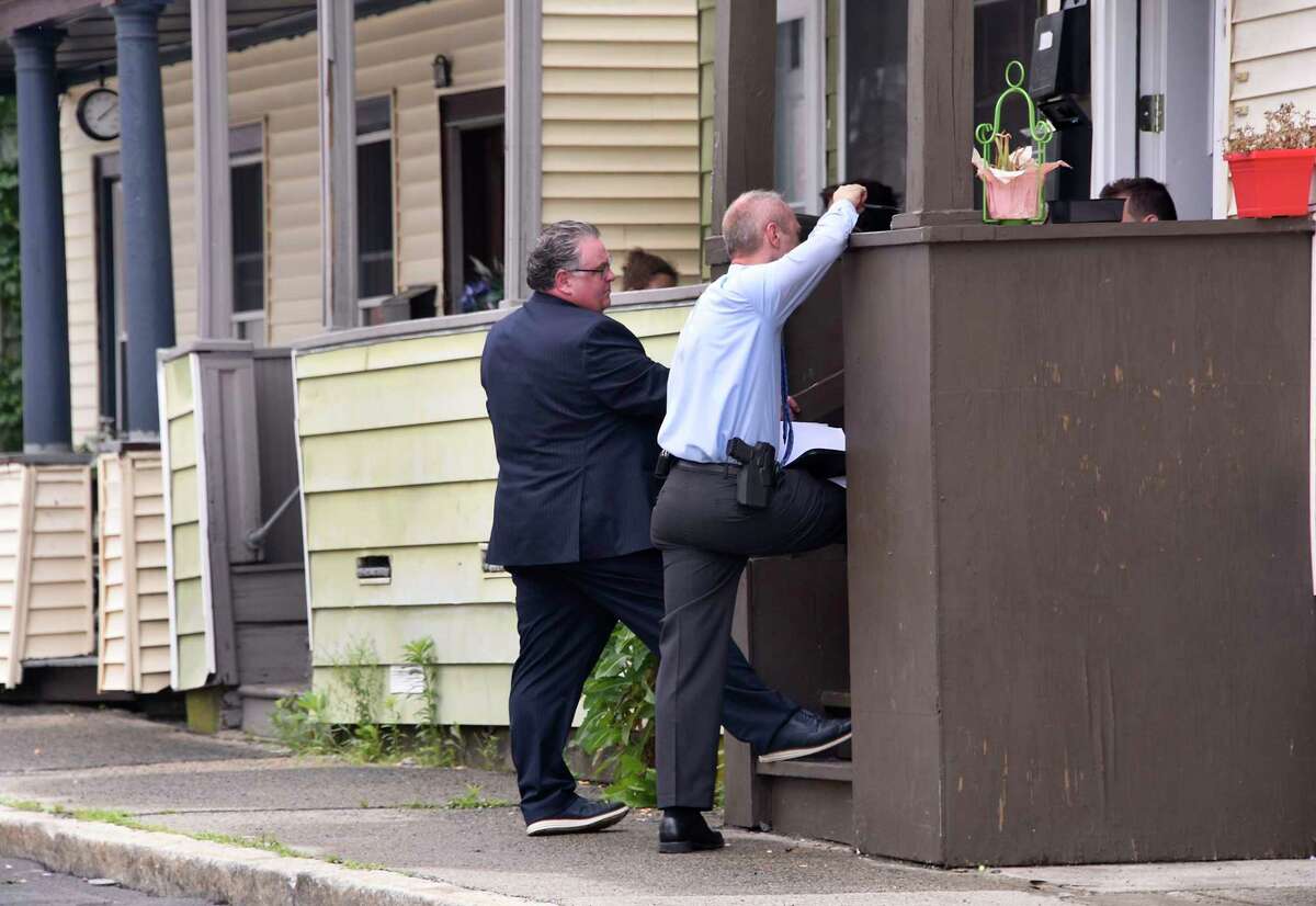 Investigators are seen questioning neighbors near the scene where 18-year-old Tyshawn Daniels died after he was shot twice on the street on Wednesday, July 1, 2020 in Cohoes, N.Y. (Lori Van Buren/Times Union)