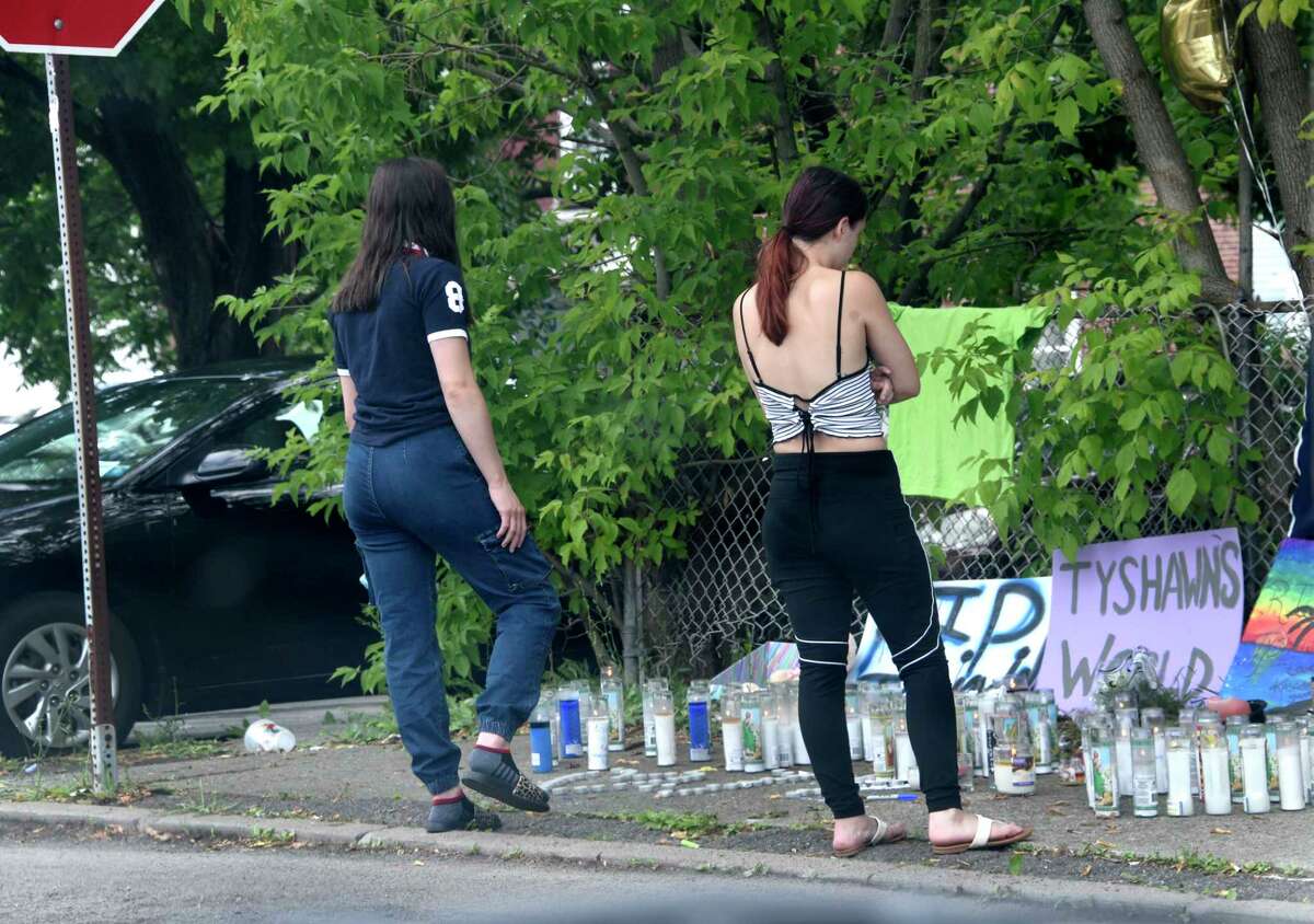 A couple girls visit a memorial at the scene where 18-year-old Tyshawn Daniels died after he was shot twice on the street on Wednesday, July 1, 2020 in Cohoes, N.Y. (Lori Van Buren/Times Union)