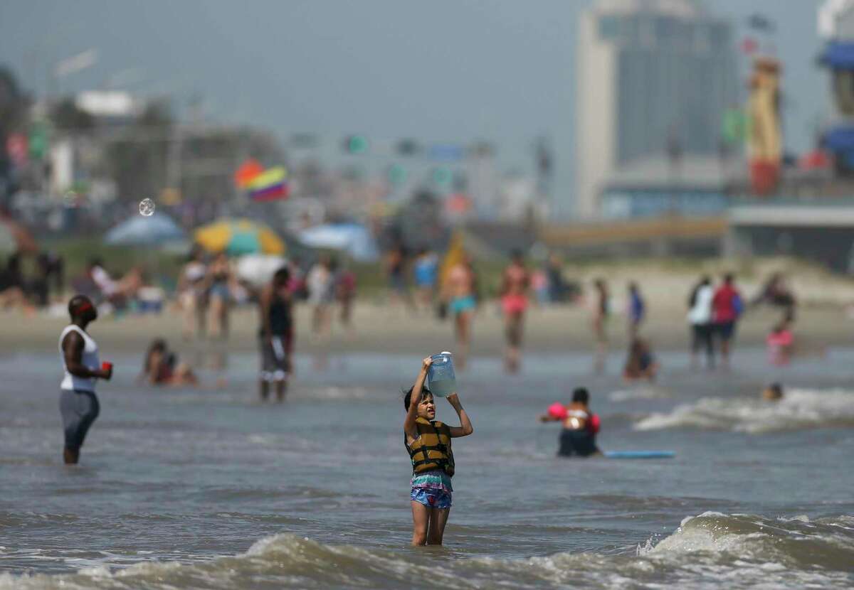People enjoy the weather at the beach near the Seawall on Sunday, May 24, 2020, in Galveston, Texas.