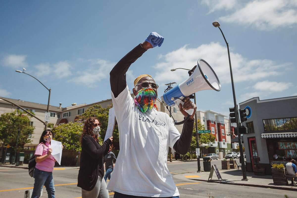 Parishoner Timothy Gholston participates in a Black Lives Matter protest outside of St. Columba Catholic Church in Oakland, Calif. on Sunday, June 28, 2020.