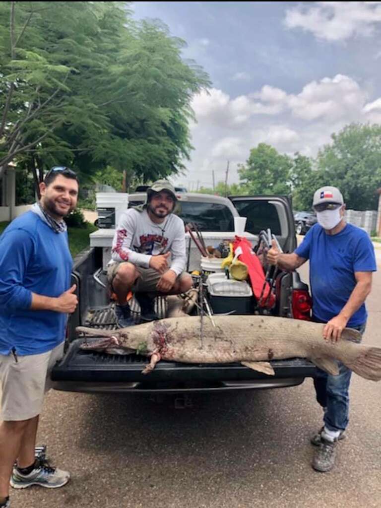 <p>Webb County Precinct 1 Commissioner Jesse Gonzalez, Meme Jasso and Pine Gonzalez pose with an alligator gar Jesse Gonzalez caught over the weekend.</p>