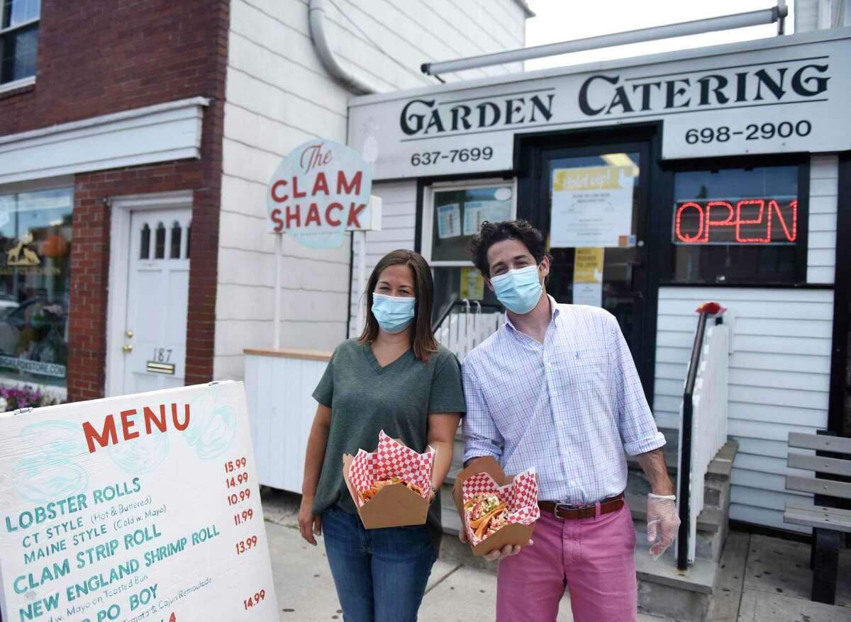 Business owners Tina Carpenteri and Frank Carpenteri Jr. show lobster rolls for sale at the new Clam Shack outside Garden Catering in Old Greenwich. The outdoor stand will be open Thursdays through Sundays in the summer, serving a variety of seafood and fried food.