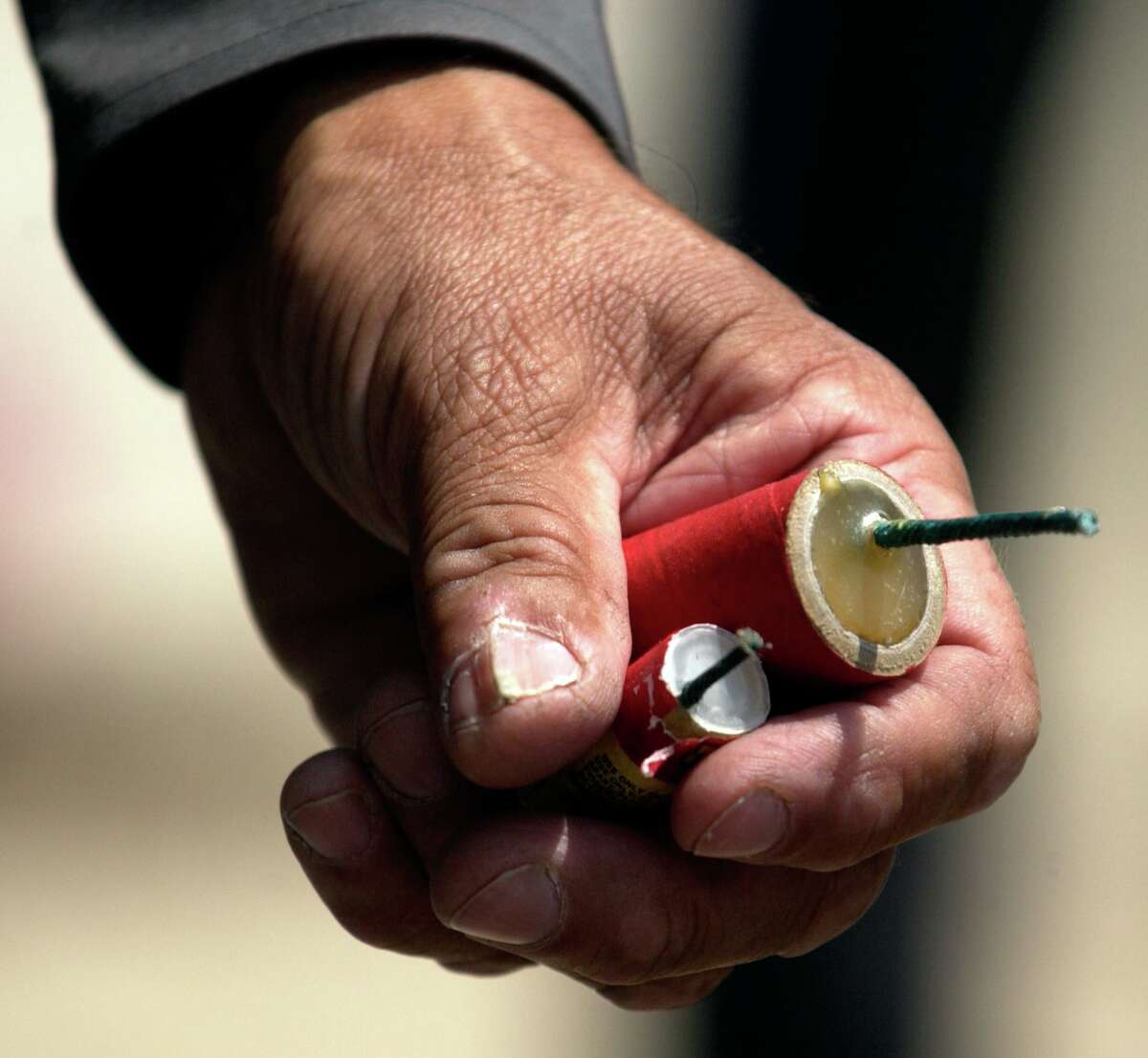 Connecticut State Police detective Jose Colon holds firecrackers of a type that is illegal in Connecticut at a news conference in Middletown, Conn., Tuesday, June 29, 2004.
