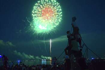 Skyrockets light up the sky over Long Island Sound at the Independence Day Fireworks Fundraising Show at Compo Beach, Monday, July 3, 2017 in Westport, Conn.