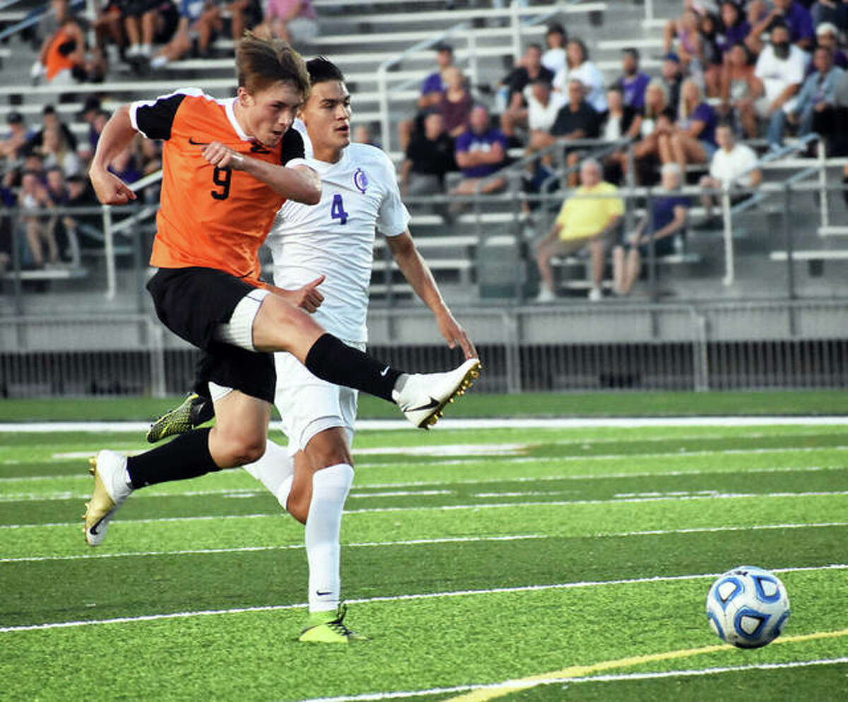 Cooper Nolan, left, sends the ball away from a Collinsville player during SWC action last season in Edwardsville.
