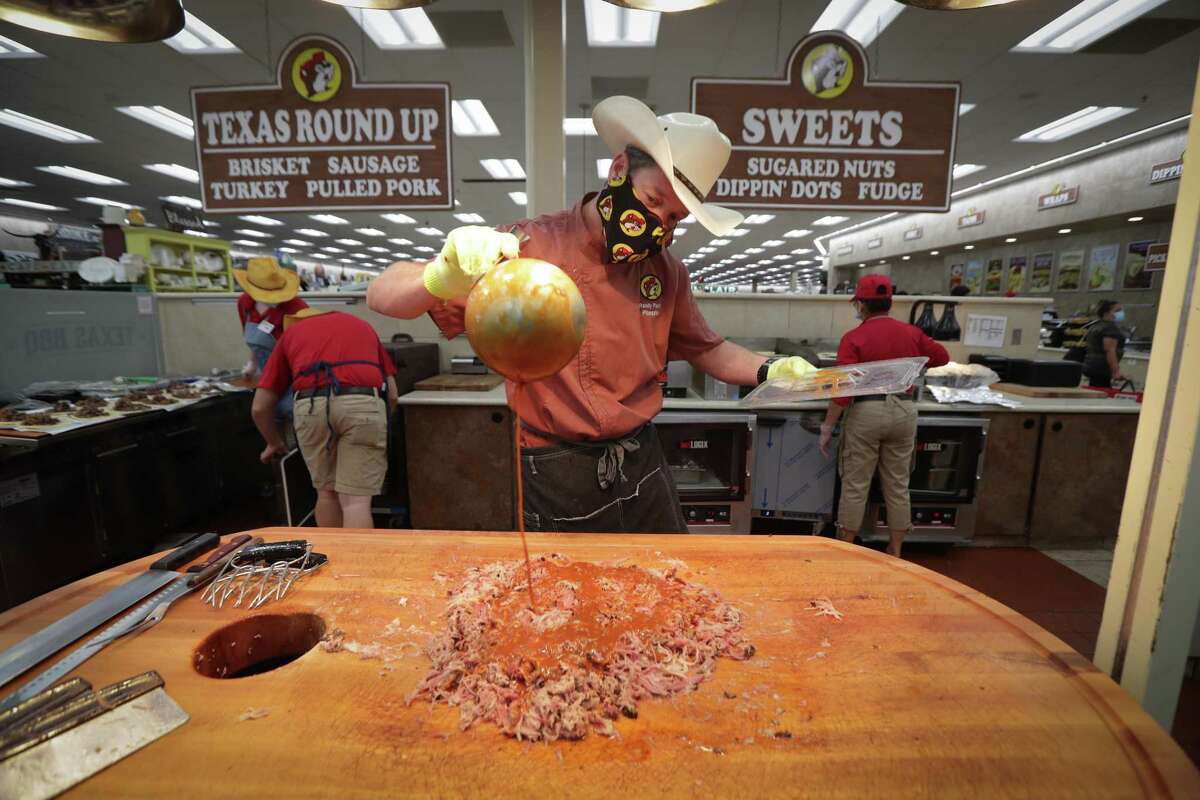 Buc-ee's Pitmaster Randy Pauly works on making pulled pork meat for sandwiches Friday, June 19, 2020, in Katy.
