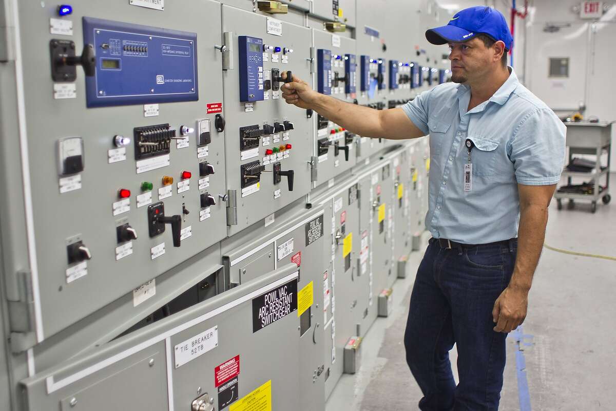 Lucas Alvarado, a quality assurance inspector, looks over the distribution switchgear in a custom power control room, Wednesday, May 29, 2013, in Powell Industries factory in Houston. ( Nick de la Torre / Chronicle )