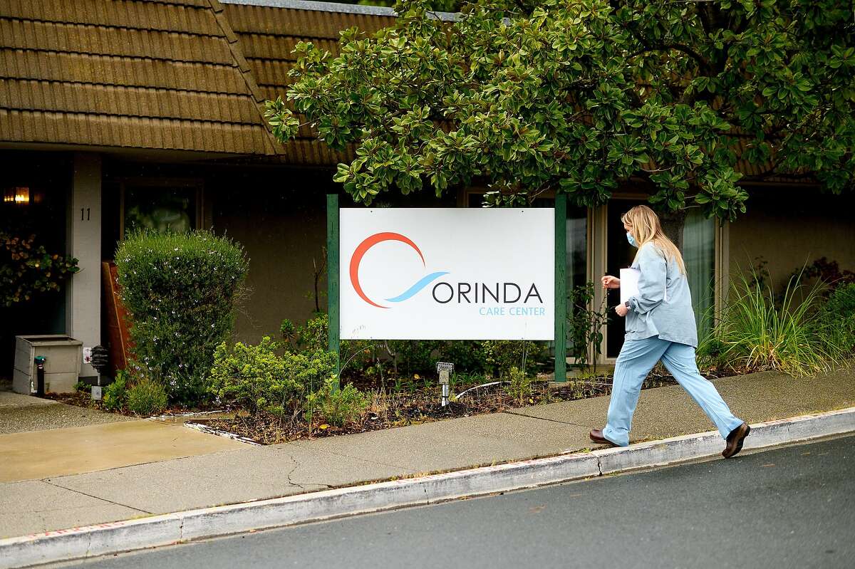 A health care worker from John Muir Medical Center prepares to enter Orinda Care Center, where nearly 50 residents and staff members have tested positive for coronavirus, on Monday, April 6, 2020, in Orinda, Calif.