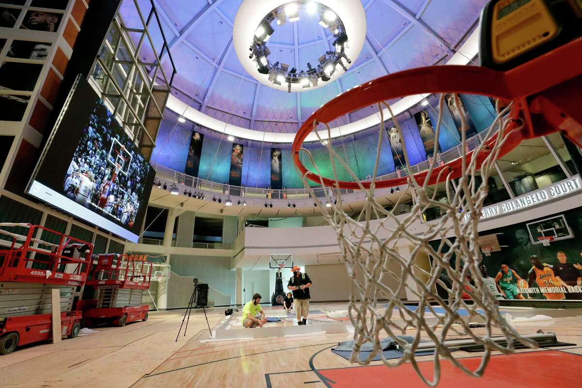 Workers perform restorations at the Naismith Memorial Basketball Hall of Fame, in Springfield, Mass., Tuesday, June 23, 2020. The museum is scheduled to reopen in the beginning of July 2020 with a whole new look after a $22 million renovation. (AP Photo/Steven Senne)