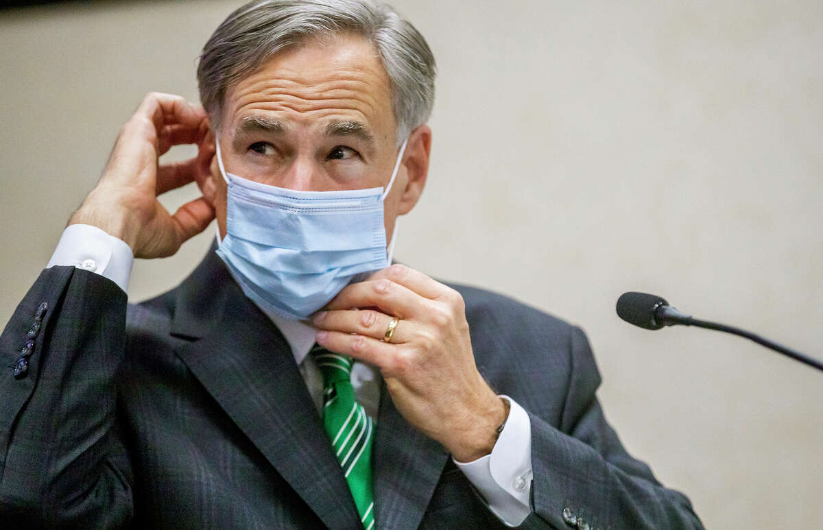 FILE - In this June 16, 2020, file photo, Texas Gov. Greg Abbott adjusts his mask after speaking in Austin, Texas. Abbott on Thursday, July 2, ordered that face coverings must be worn in public across most of the state, a dramatic ramp up of the Republican's efforts to control spiking numbers of confirmed coronavirus cases and hospitalizations. (Ricardo B. Brazziell/Austin American-Statesman via AP, File)