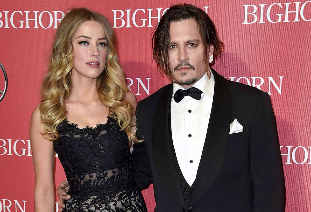 FILE - In this Jan. 2, 2016, file photo, Amber Heard, left, and Johnny Depp arrive at the 27th annual Palm Springs International Film Festival Awards Gala in Palm Springs, Calif. In a complaint filed Friday, March 1, 2019, Depp is suing his ex-wife Heard in a $50 million defamation lawsuit, citing a piece she wrote for The Washington Post about domestic abuse. (Photo by Jordan Strauss/Invision/AP, File)