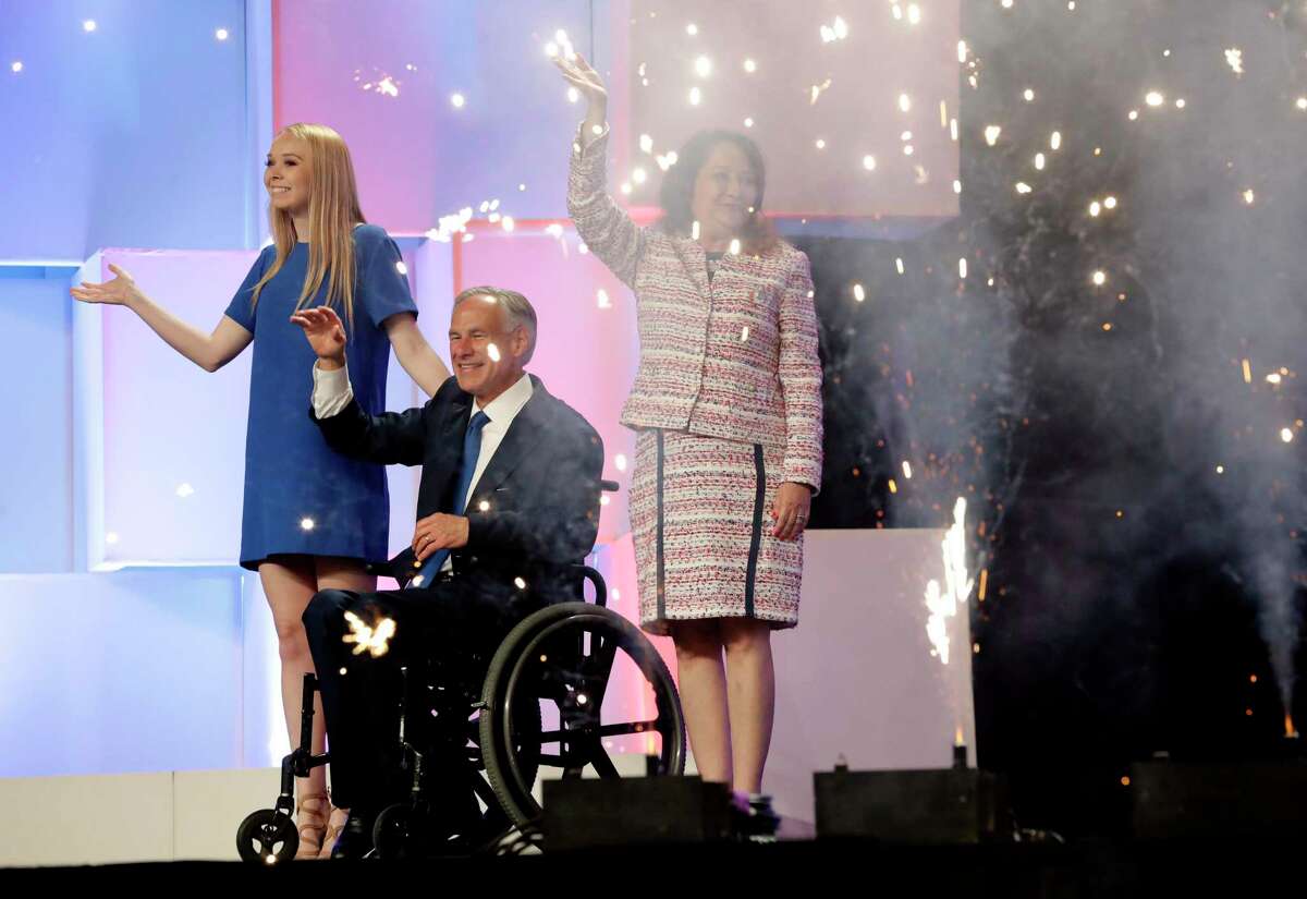In this June 15, 2018 file photo, Texas Gov. Greg Abbott, center, with wife, Cecilia, right, and daughter, Audrey, at the Texas GOP Convention, in San Antonio. After the Texas GOP executive committee voted to press ahead with plans for an in-person convention in downtown Houston later this month, the Texas Medical Association announced it was withdrawing as a sponsor of the event. (AP Photo/Eric Gay File)