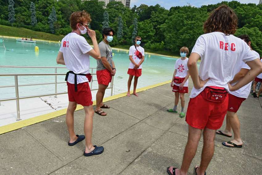 Lifeguards wear protective face masks and practice social distancing as they talk about the day's plans moments before the Lincoln Park pool opens for the season on Friday, July 3, 2020 in Albany, N.Y. (Lori Van Buren/Times Union)