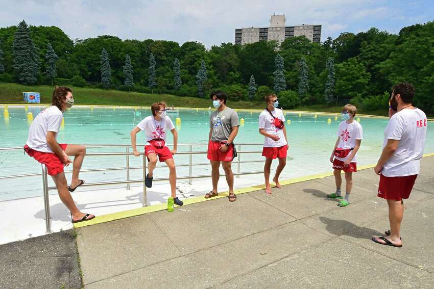 Lifeguards wear protective face masks and practice social distancing as they talk about the day's plans moments before the Lincoln Park pool opens for the season on Friday, July 3, 2020 in Albany, N.Y. (Lori Van Buren/Times Union)