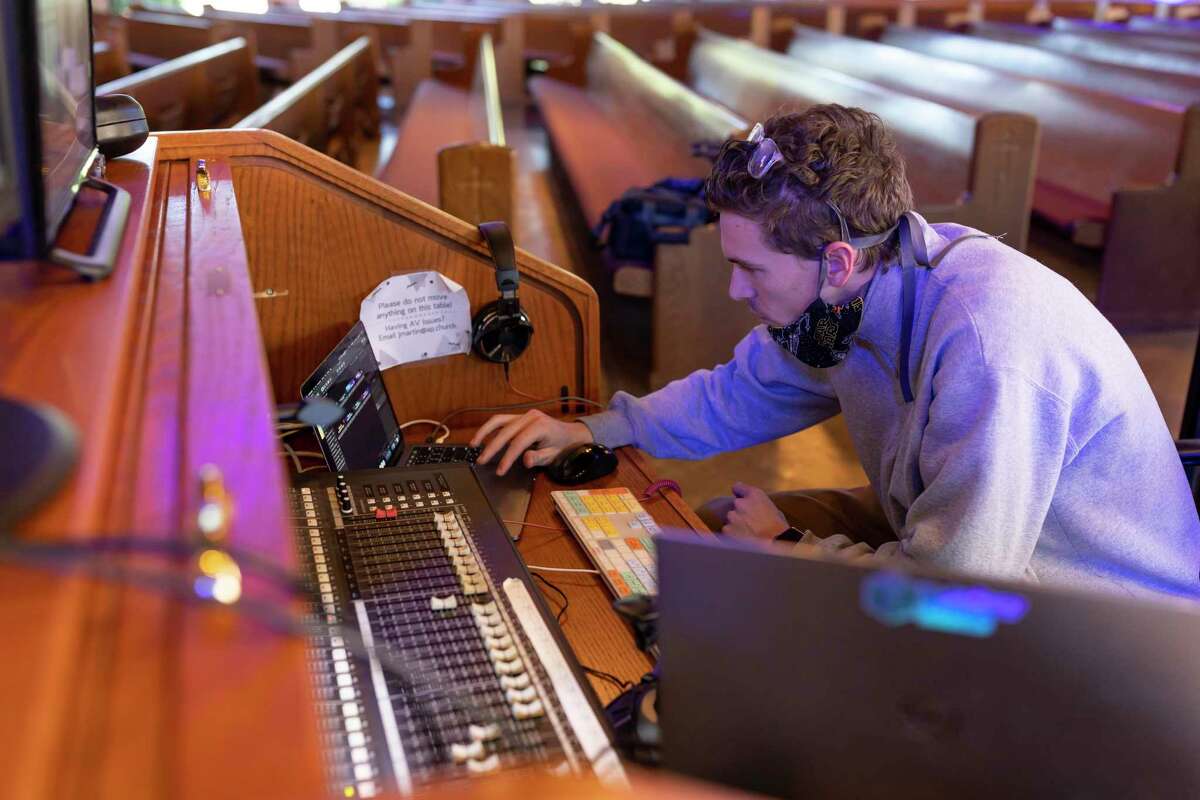 Jay Martin, creative services technician for St Anthony of Padua Catholic Church in The Woodlands, prepares his equipment before mass, Sunday, April 26, 2020. The church began regularly hosting streaming services of their masses in the summer of 2019.