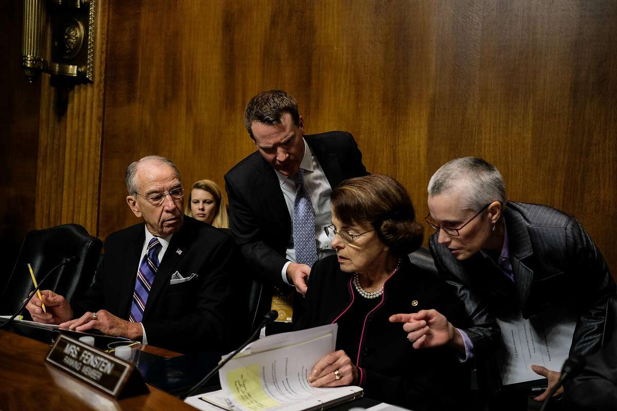 WASHINGTON, DC - SEPTEMBER 27: U.S. Senate Judiciary Committee Chairman Chuck Grassley (R-ID) and ranking member Dianne Feinstein (D-CA) talk with aides during testimony from Christine Blasey Ford and Supreme Court nominee Brett Kavanaugh at the Dirksen
