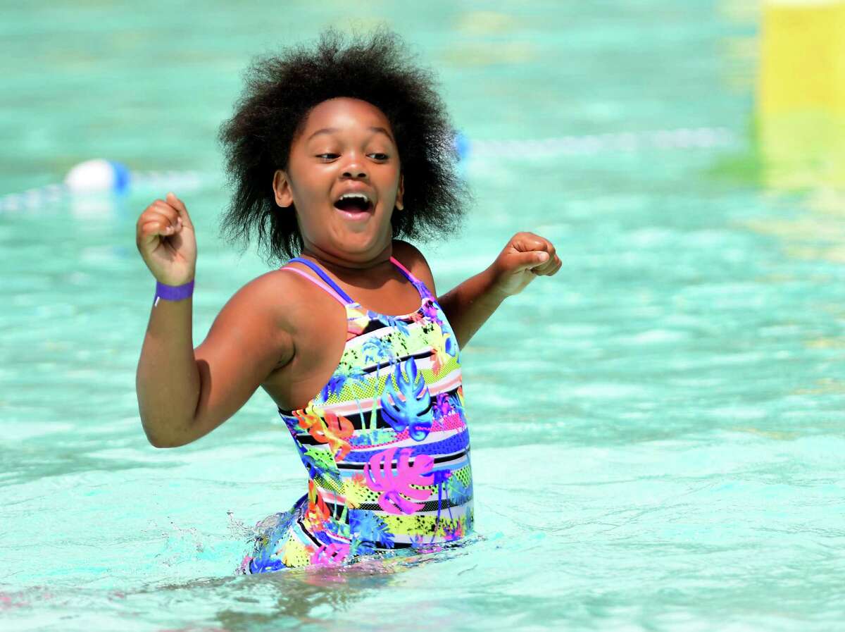 Serenity McKnight, 9, of Albany gets used to the coldness of the water as she takes her first swim at the Lincoln Park pool last summer in Albany. One Times Union reader said Albany should use its stimulus money to rebuild the pool. (Lori Van Buren/Times Union)