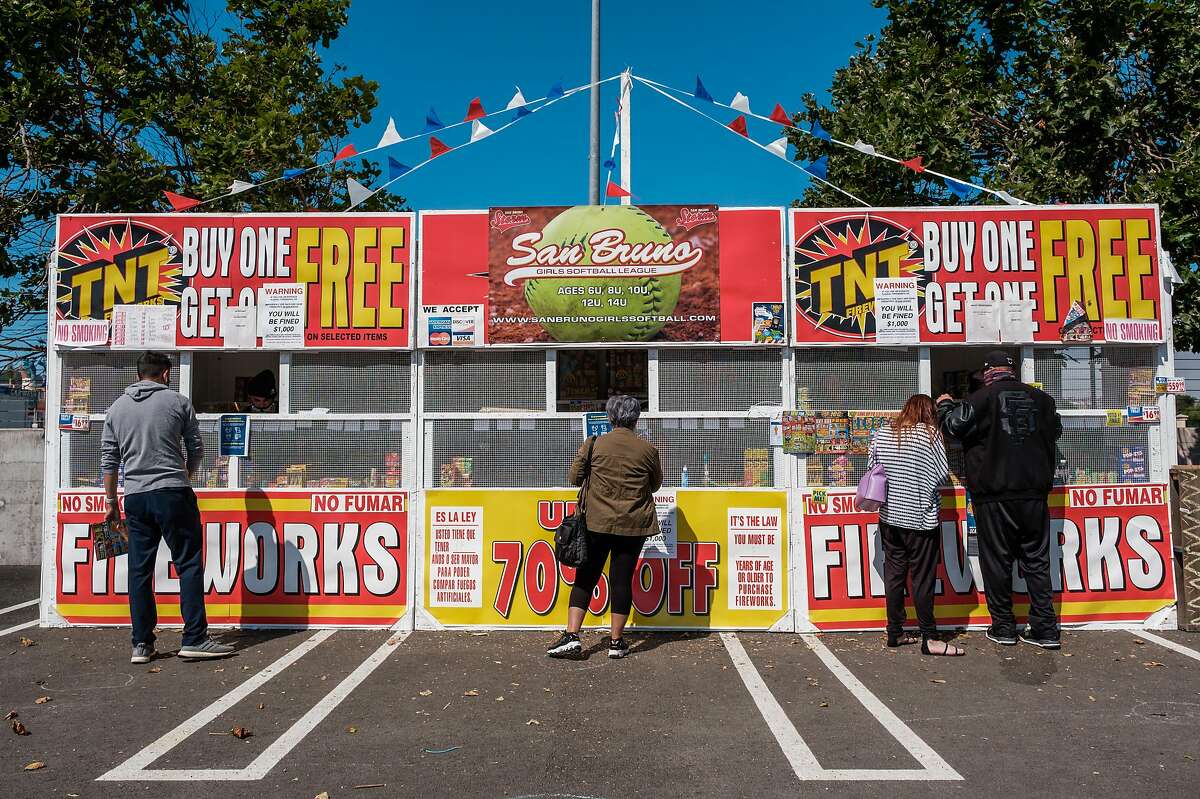 People line up to buy fireworks from a stand in San Bruno on Friday, July 3, 2020.