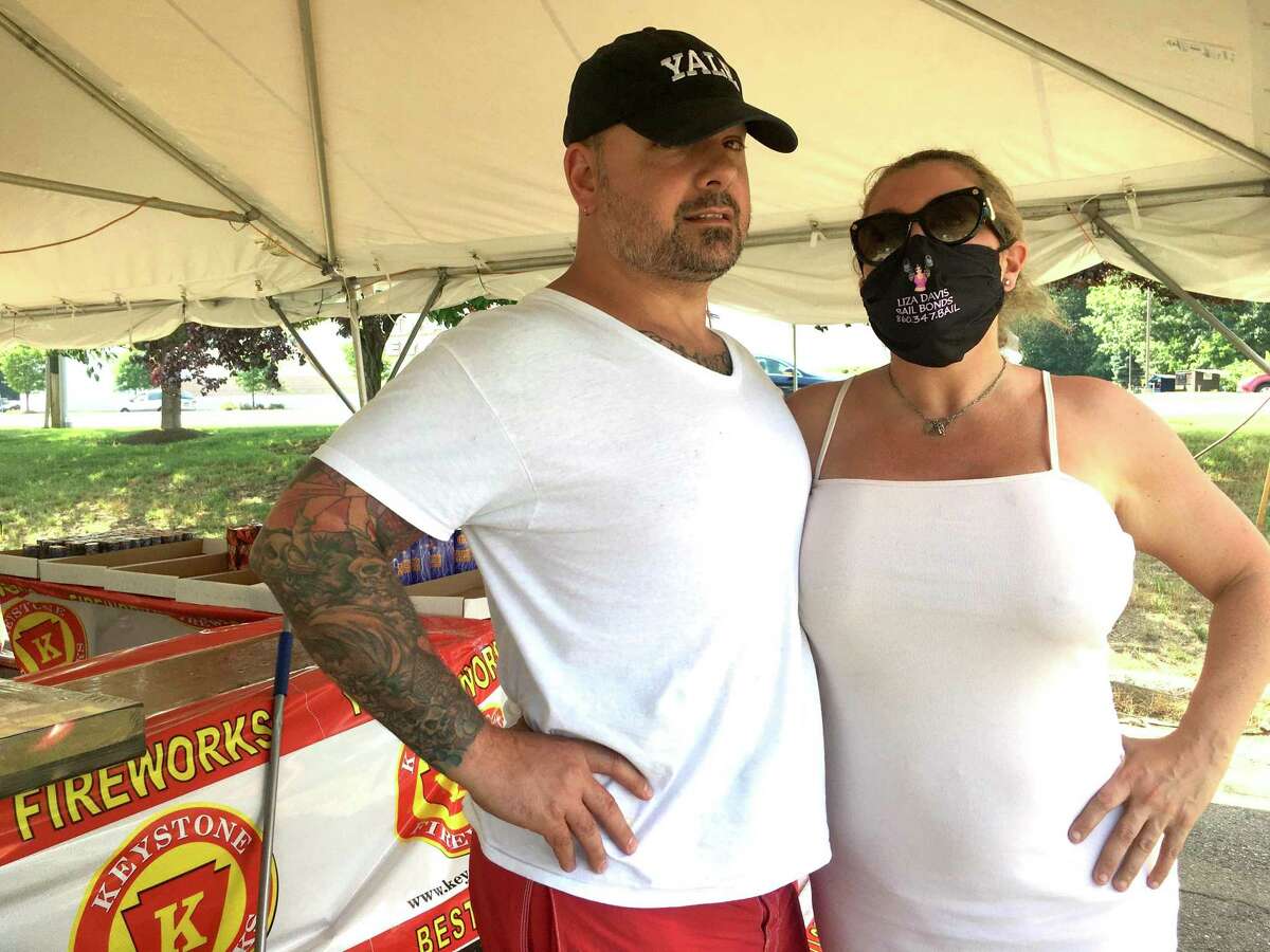 On Independence Day, attitudes about masks for coronavirus reflect the principles of the founding of the United States. Pictured are Massimo DeMedici and Liza Davis, in the bail bonds business, who have complex ideas about masks; and a scene in South Norwalk where a group of friends including A.J. Ibarrondo greeted one another with hugs.