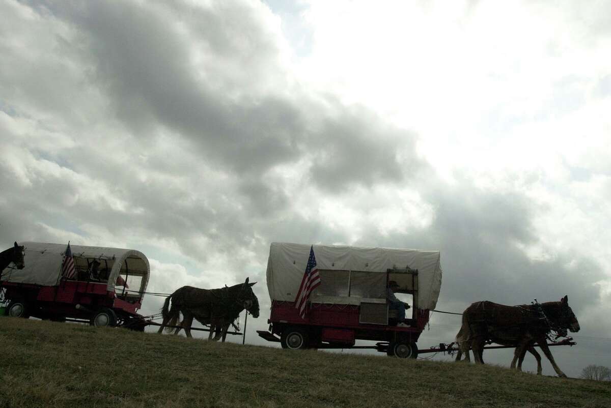 These covered wagons are in the middle of the 15-mile journey from La Vernia to China Grove on Wednesday, Jan. 30, 2002, the fifth day of the trail ride sponsored by the Old Chisholm Trail Drivers Association. Their 100-mile journey started in Cuero and ends in San Antonio for the 53rd San Antonio Livestock Show and Rodeo. There are some who say the original Chisholm Trail expanded southward into Texas down to Cuero, but scholars disagree.